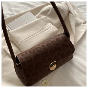 Close-up of brown leopard print shoulder bag with gold metal buckle and suede texture