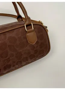 Detail of leopard print embossed suede and premium brown leather piping on Boston bag