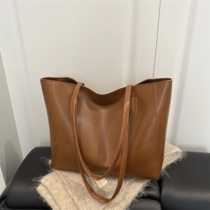 Classic large brown leather tote bag for women with minimalist shoulder straps design