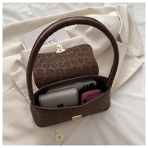 Top view of leopard print handbag showing interior capacity for phone and wallet