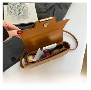 Detailed view of the brown PU leather crossbody bag interior showing storage capacity