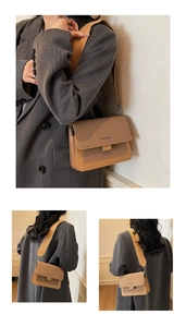 Detail of minimalist contrast-color square bag with stylish orange wide shoulder strap