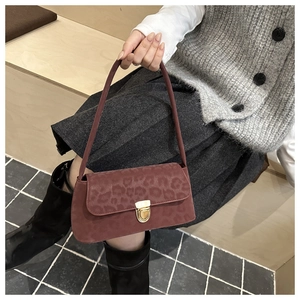 Détail du sac vintage imprimé léopard avec fermoir doré et texture en daim doux