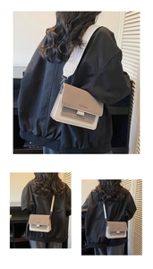 Detail of a color-block square crossbody bag with wide shoulder strap and flap closure
