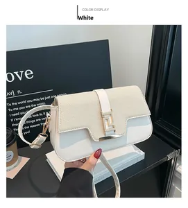 Detail of white leather and beige woven fabric saddle bag with golden metal buckle