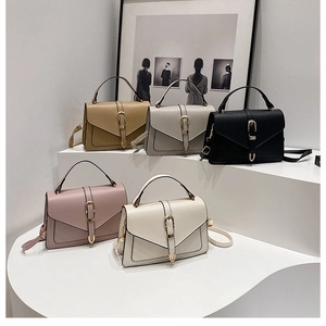 Detailed group view of five colors of leather crossbody bags with gold hardware buckles