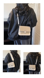 Detailed back view of a minimalist color-block crossbody bag on a model in a cozy interior