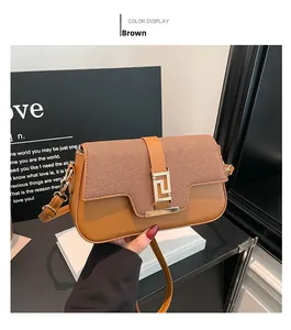 Detail of a brown shoulder bag with woven texture flap and golden buckle decor