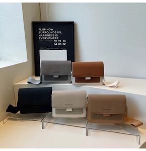 Detail shot of vintage matte flap square bags in five colors with wide woven straps