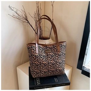 Detailed close-up of a leopard print tote bag featuring a leather Fashion patch and handle