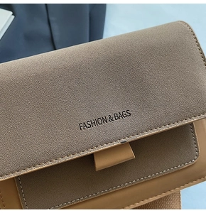 Close-up of warm brown leather texture and Fashion & Bags text on crossbody bag