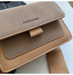 Detail of khaki square crossbody bag with suede texture and wide woven shoulder strap