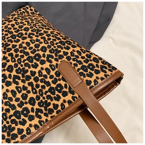 Close-up of leopard print tote bag showing durable canvas texture and brown PU leather straps