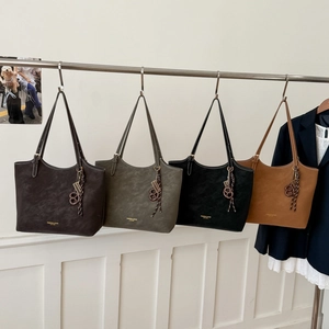 Retro faux suede large tote bags in dark brown, green, and black shown in a lifestyle set