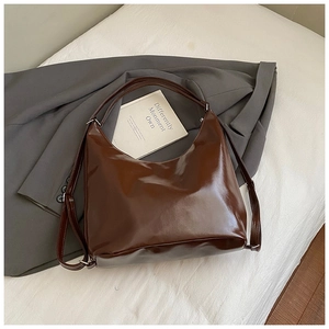 Detailed view of the vintage brown oil-wax leather hobo bag with silver hardware