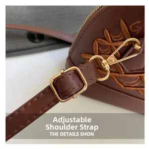 Close-up of adjustable strap with gold buckle on dark brown quilted shoulder bag