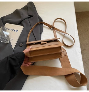 Detailed top view of caramel brown crossbody bag with multi-layer accordion compartments