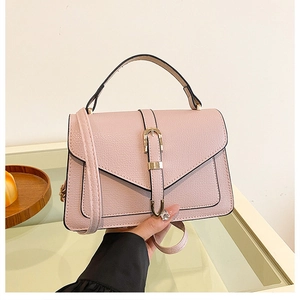Pink minimalist crossbody bag with lychee grain leather and gold belt buckle detail
