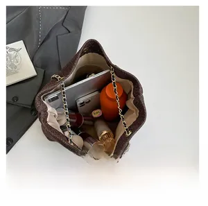 Spacious dark brown metallic tote bag showing storage for a tablet, phone, and cosmetics