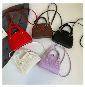 Detailed display of embroidered shell handbags in five colors with cross pattern texture