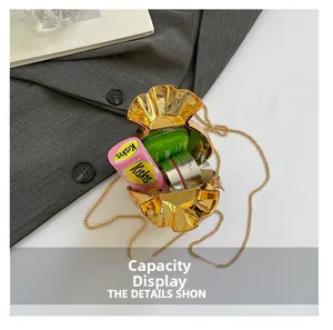 Internal capacity view of gold money bag clutch showing mini cosmetics and accessories