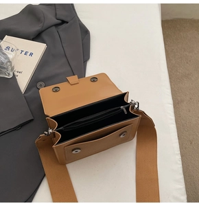 Interior view of the khaki crossbody bag showing main compartment and zipper pocket