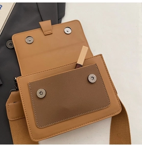 Detail of brown square crossbody bag showing inner pocket with lipstick and magnetic closure