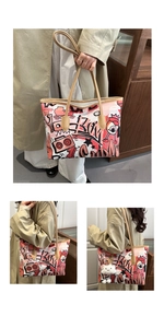 Detail of graffiti tote bag with pink comic prints, brown handles and plush cloud charm