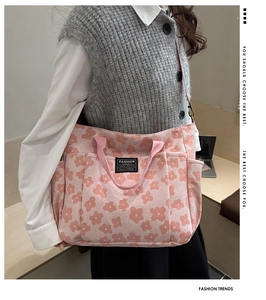 Detail of pink floral canvas tote bag with adjustable strap and side pocket detail