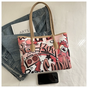 Detailed top view of a graffiti tote bag with shoulder straps and leather trim accents