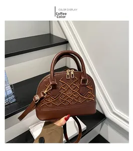 Detail of coffee brown Boston bag featuring crown embroidery and gold hardware accents
