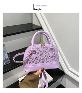 Detailed view of the purple shell bag featuring intricate cross-line embroidery and gold zippers