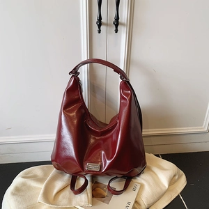 Retro deep red glossy patent leather tote bag with large capacity and hobo silhouette