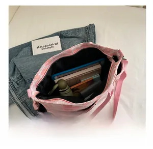 Large capacity floral tote bag interior showing books, tablet, and daily essentials