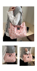 Detail view of large floral tote bag showing front pocket and black Fashion label