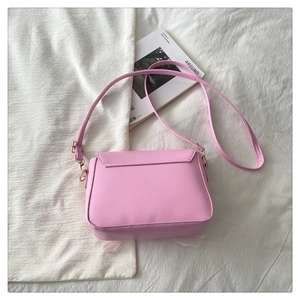 Detailed view of pink crossbody bag featuring decorative tulle trim and PU leather texture