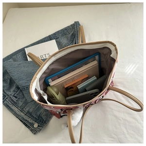 Spacious tote bag interior showing large capacity for tablet, umbrella and books