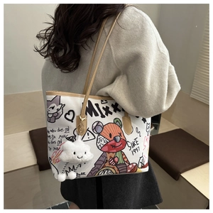 Detail of white graffiti tote bag with plush cloud charm and colorful illustrations