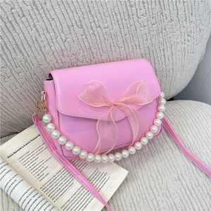Pink pearl handle crossbody bag with mesh bow and polished faux leather finish