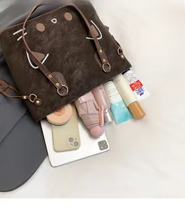 Top view of spacious cat-themed tote bag showing storage for umbrella and tablet