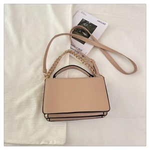 Detailed top view of beige flap square bag with chain accent and contrast oil edges