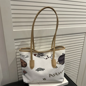Large white canvas tote bag with astronaut pattern and brown leather straps for winter 2025