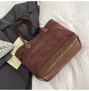 Vue détaillée du sac cabas marron montrant les textures mixtes de daim et cuir lisse