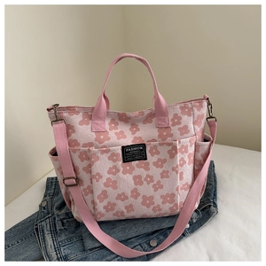 Detail of pink floral canvas tote with multi-pockets and adjustable shoulder strap