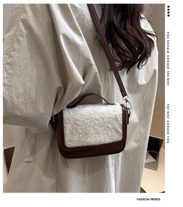 Side view of a vintage crossbody bag featuring brown leather and white faux fur texture