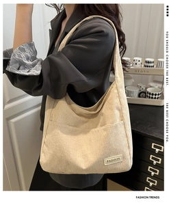Détail du sac cabas en velours côtelé beige montrant l'étiquette sur le tissu côtelé