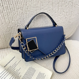 Navy blue faux leather crossbody bag with dual-tone metal buckle and chain strap