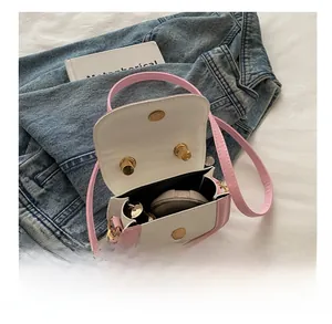 Internal view of mini pink leather crossbody bag showing space for lipstick and makeup