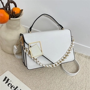 Chic white crossbody bag with geometric buckle and woven chain strap on beige carpet