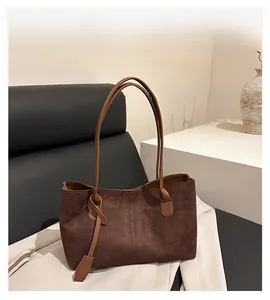 Detail of dark brown faux suede tote bag featuring fine texture and vertical stitching